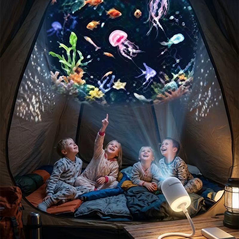 Family camping in a tent with the Galaxy Star Projector lighting the ceiling with a colorful jellyfish scene