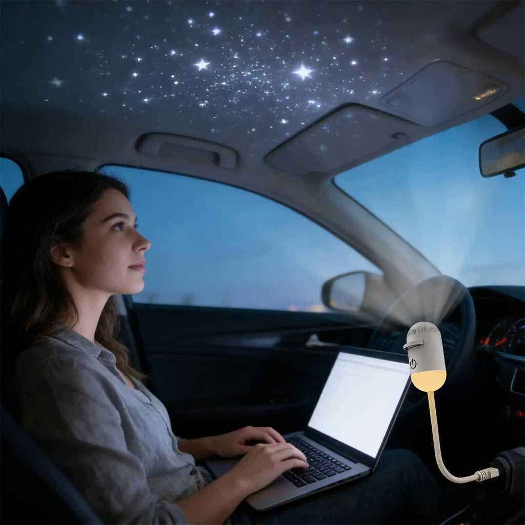 Galaxy Star Projector lighting up a car ceiling with stars while a woman works on her laptop
