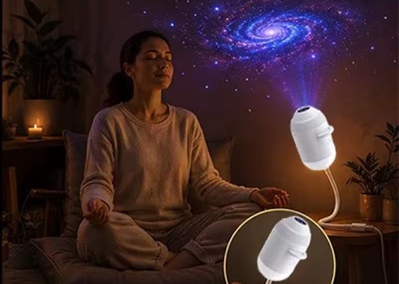 Woman meditating under a galaxy projection from the Galaxy Star Projector